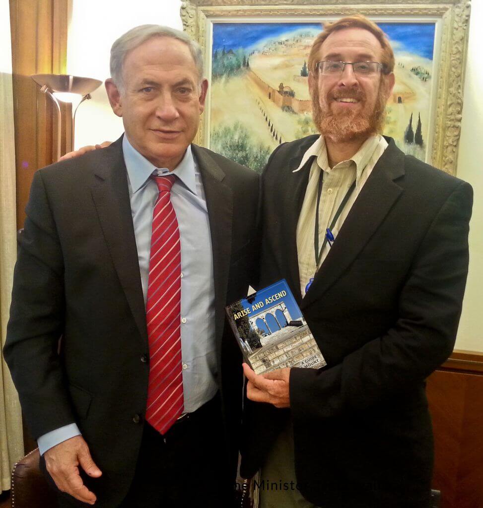 Netanyahu poses with Yehuda Glick, who is holding his Temple Activist “guide book” to the Temple Mount