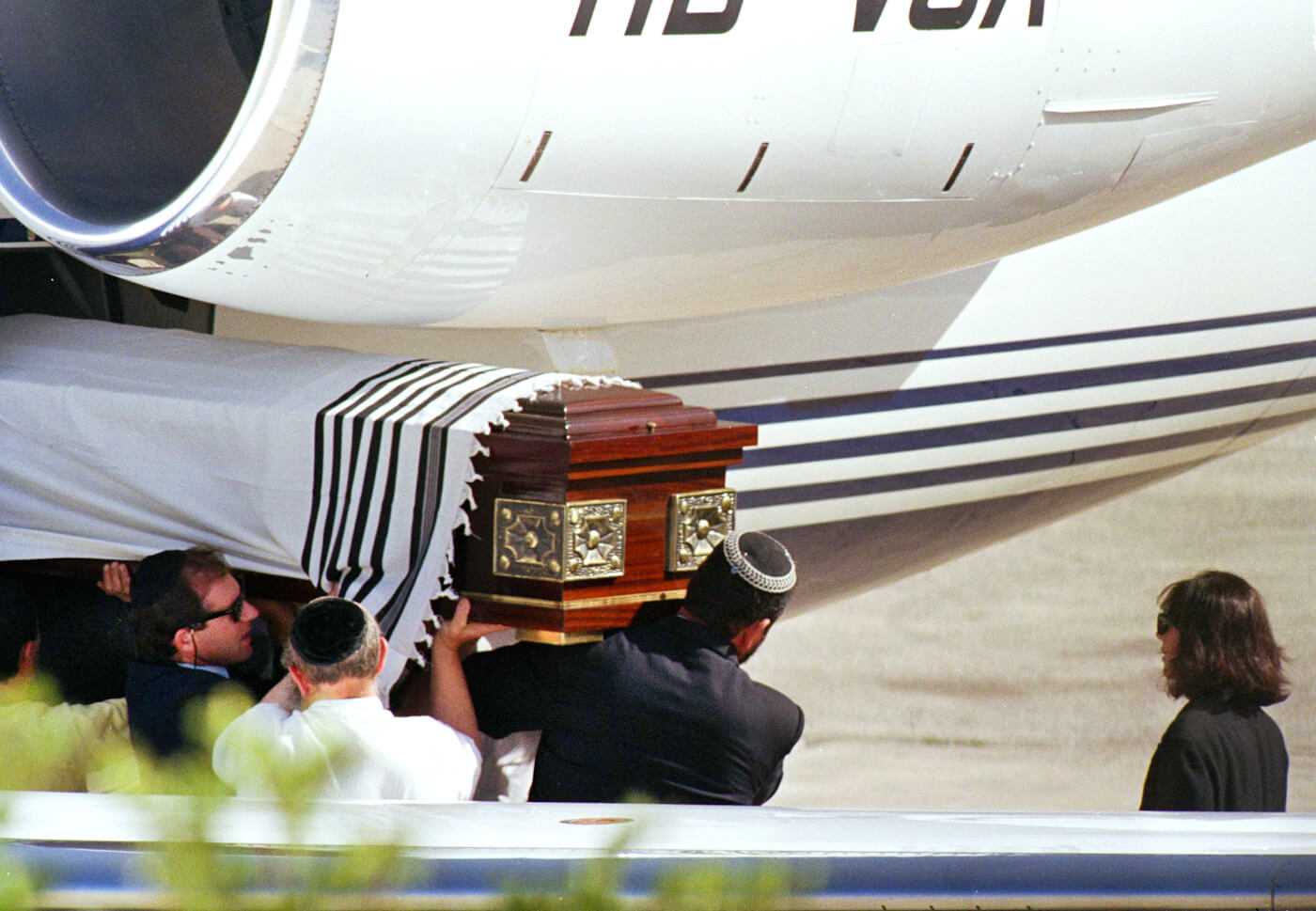 Ghislaine Maxwell, far right, Robert Maxwell’s daughter, looks on his casket is unloaded from a plane in Jerusalem, Nov. 8, 1991. Heribert Proepper | AP