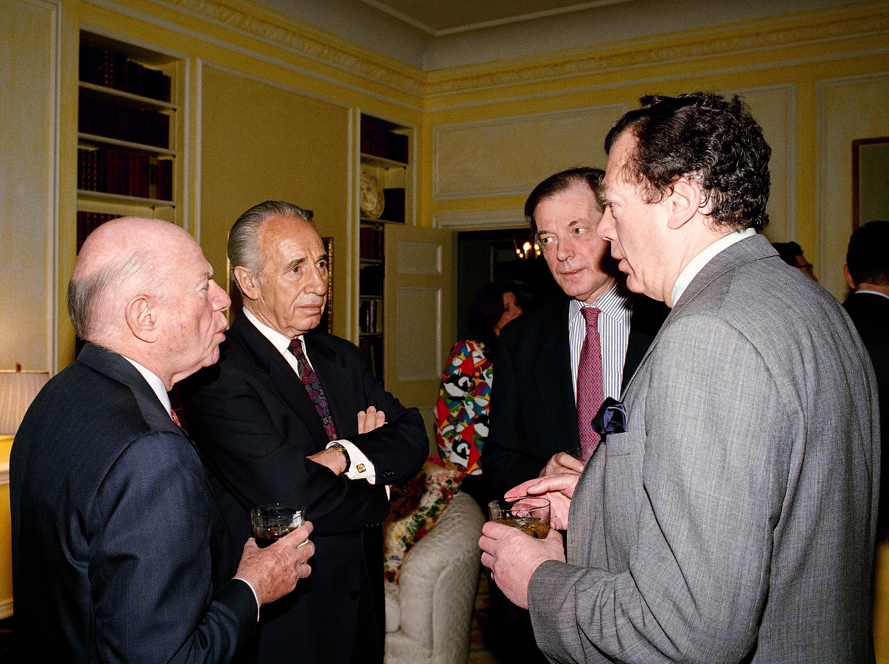 Former Israeli president Shimon Peres, second from left, listens to Edgar Bronfman during a 1995 lunch thrown in Peres’ honor. From left are: Laurence Tisch, Chairman, President and Chief executive officer of CBS; Israeli Ambassador to the United States. Itamar Rabinowitz and Bronfman. David Karp | AP