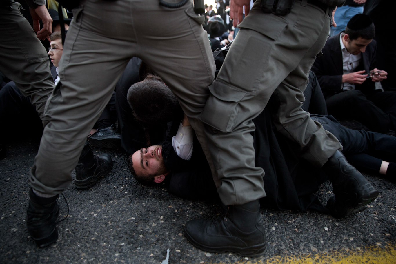 Israeli police clash with ultra-Orthodox men protesting the arrest of a person who refused military service in Bnei Brak, Israel, March 12, 2018. Oded Balilty | AP