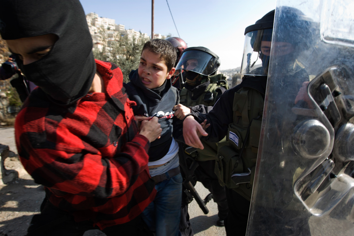 Israeli police disguised as civilians arrest a Palestinian boy during protests over Jewish-only settlements in Silwan, Jan. 28, 2011. Sebastian Scheiner | AP
