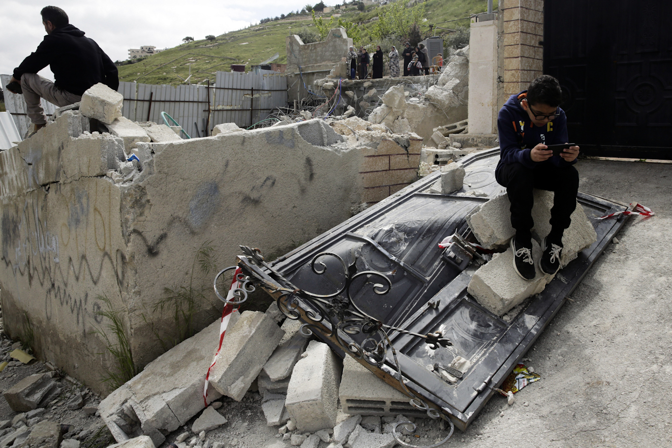 Palestinians watch as Israeli authorities destroy their family home in the East Jerusalem neighborhood of Silwan, April 17, 2019. Mahmoud Illean | AP