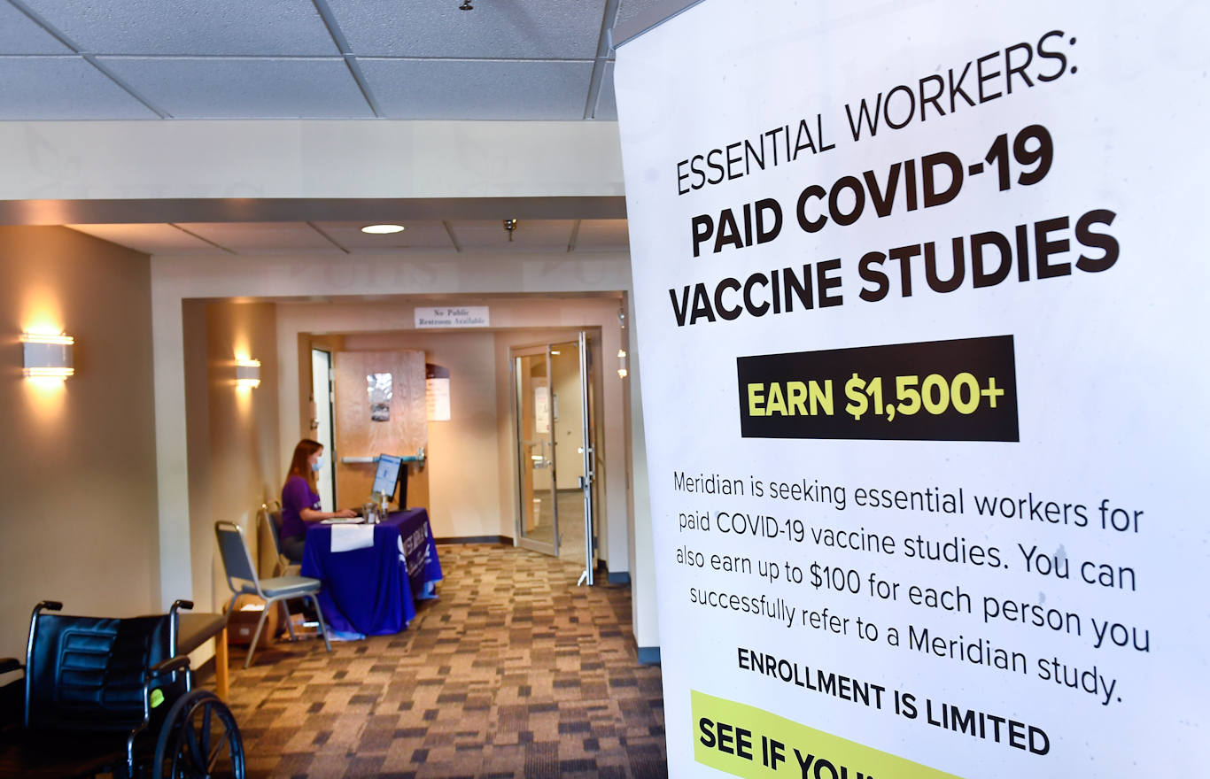 A poster seeking volunteers to take part in a COVID-19 vaccine study by the NIH and Moderna Inc., July 27, 2020, in Binghamton, N.Y. Hans Pennink | AP