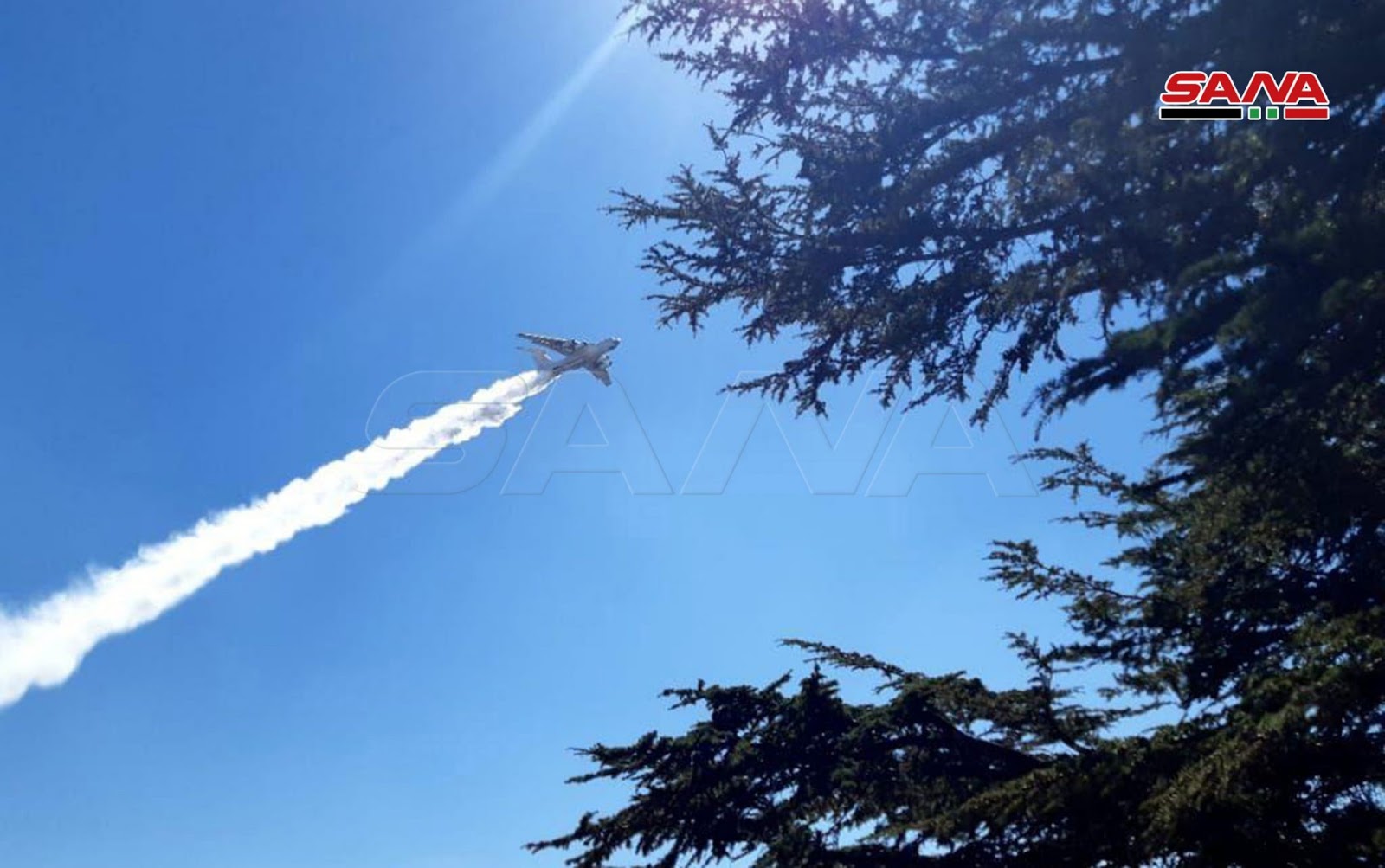 An Iranian fire-fighting plane assists Syrian Air-force helicopters in battling fires. Photo: SANA.