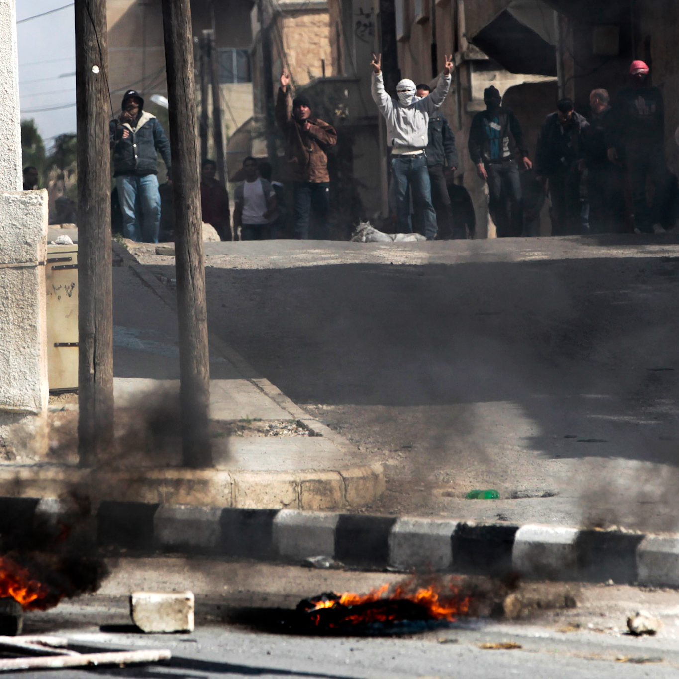 Anti-government protesters flash victory signs in the southern city of Daraa, Syria, March 23, 2011. Photo: Hussein Malla/AP.