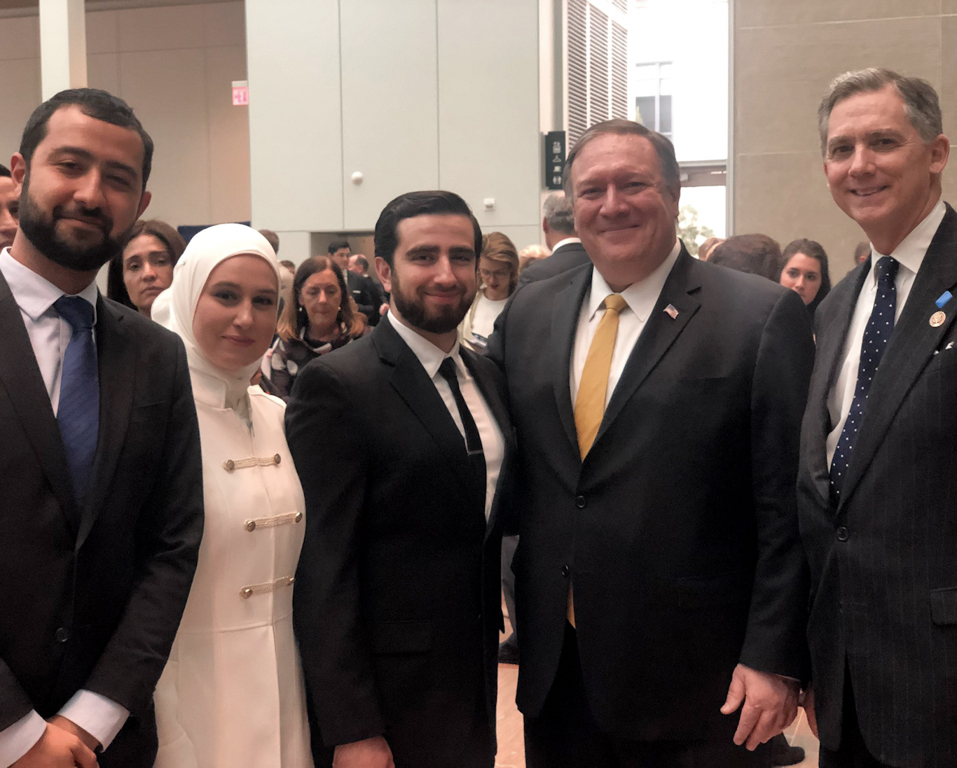 Mouaz Moustafa (left) stands with Mike Pompeo, second right, and Joe Wilson, right, at an event condemning the Syrian government. Source: Twitter