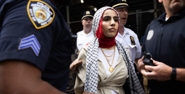 NYPD officers arrest a woman as pro-Palestine and pro-Israel protesters clash outside Baruch College in New York, June 5, 2024. Melissa Bender | AP