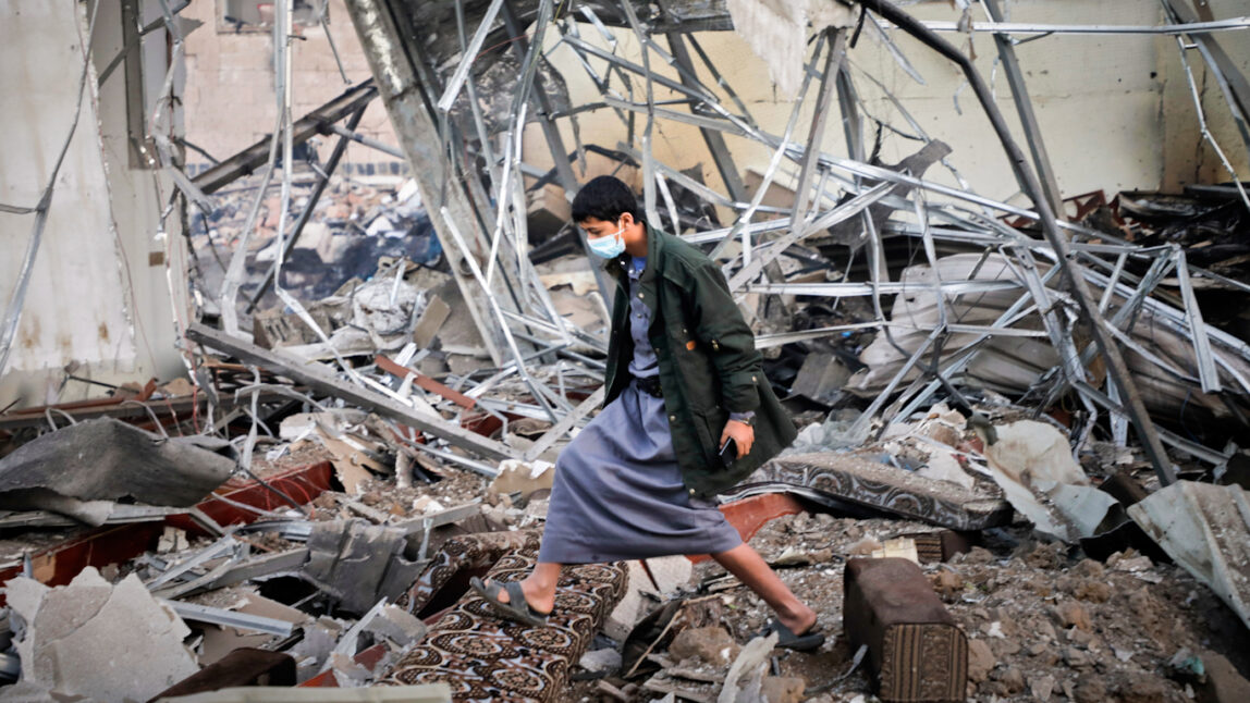 Yemeni civilians inspect rubble after U.S. airstrikes in Sana’a, March 2025