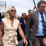 Greene and Massie walk through Capitol surrounded by reporters, April 30, 2024