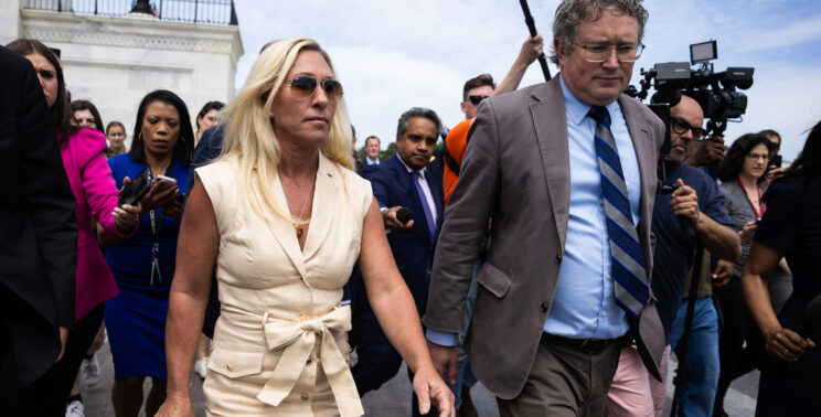 Greene and Massie walk through Capitol surrounded by reporters, April 30, 2024
