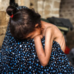 Malnourished Palestinian child held by mother in Gaza shelter during famine, May 2025