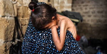 Malnourished Palestinian child held by mother in Gaza shelter during famine, May 2025