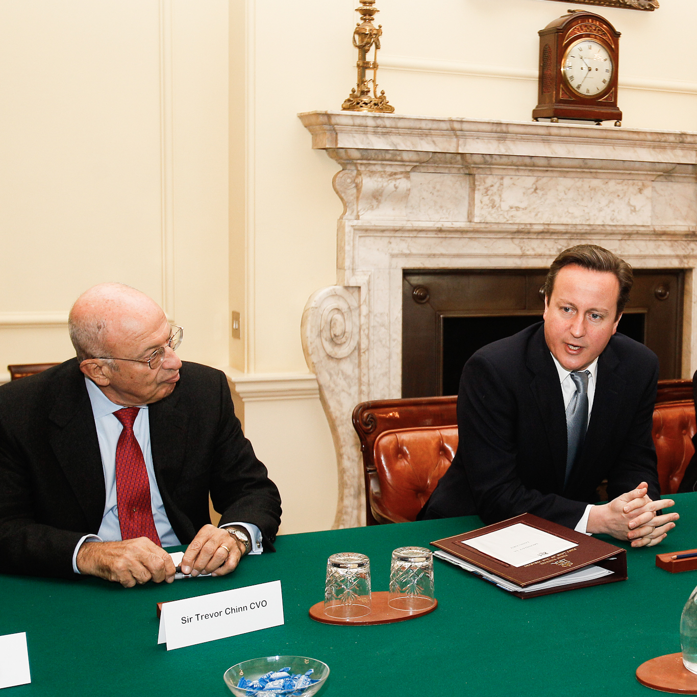 Chinn (left) looks at British Prime Minister David Cameron during a Jewish Leadership Council meeting at 10 Downing Street, Jan. 16, 2012. Kirsty Wigglesworth | AP