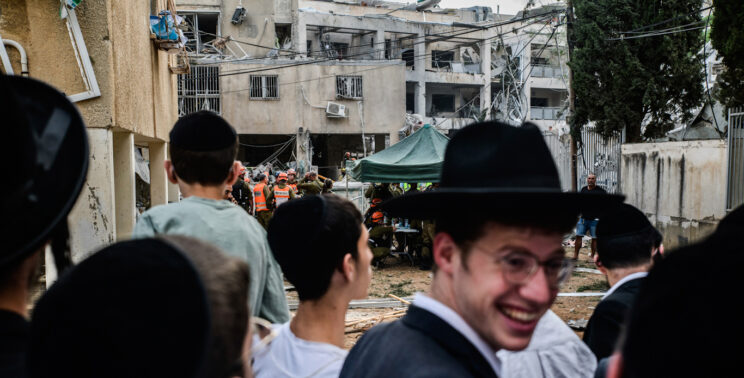 Israelis gather next to a direct hit site following an Iranian missile strike against Israel, June 16th 2025. Matan Golan | AP