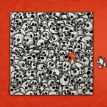 A jigsaw puzzle made of black-and-white cartoon skulls, nearly complete, with one missing piece on a red background.
