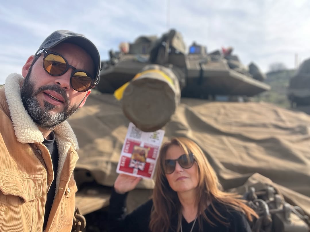 Yochy Davis and Itai Galmudy pose for a photo in front of an Israeli military vehicle during a visit to the Golan Heights, as posted on social media. (Instagram)