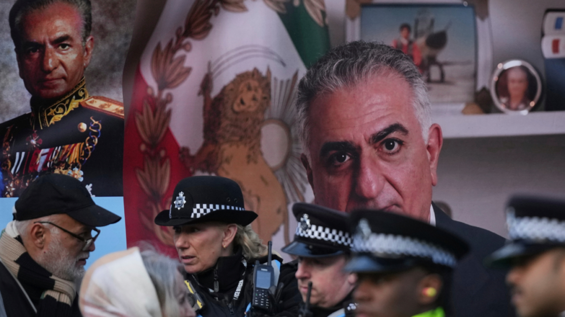 Police speak to demonstrators as they hold placards, banner and flags as they protest outside the Iranian Embassy in London, Jan. 16, 2026. Alastair Grant | AP