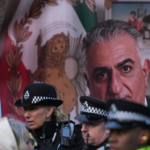 Police speak to demonstrators as they hold placards, banner and flags as they protest outside the Iranian Embassy in London, Jan. 16, 2026. Alastair Grant | AP