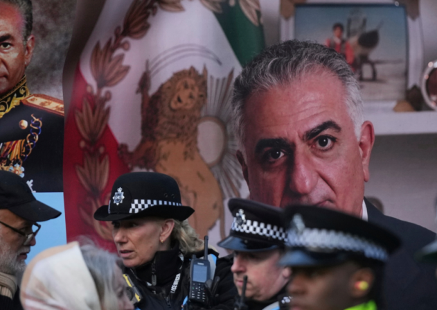 Police speak to demonstrators as they hold placards, banner and flags as they protest outside the Iranian Embassy in London, Jan. 16, 2026. Alastair Grant | AP