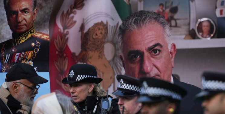 Police speak to demonstrators as they hold placards, banner and flags as they protest outside the Iranian Embassy in London, Jan. 16, 2026. Alastair Grant | AP